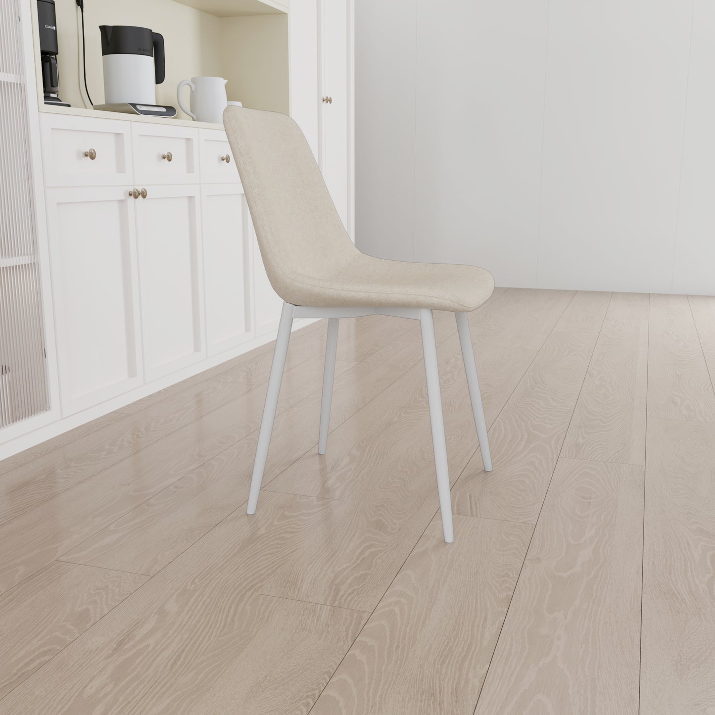 Beige upholstered dining chair with white metal legs on light wood floor