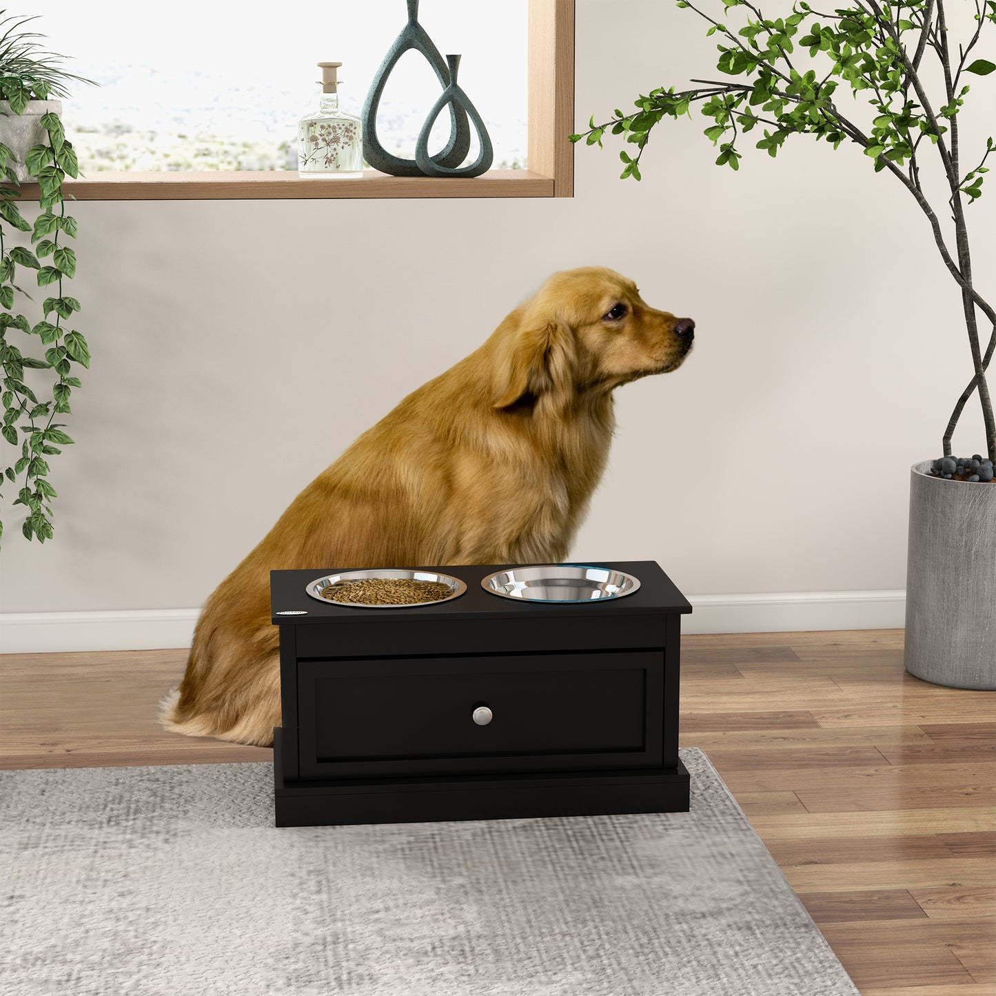 Black raised pet feeder with two stainless steel bowls and a storage drawer for dog supplies
