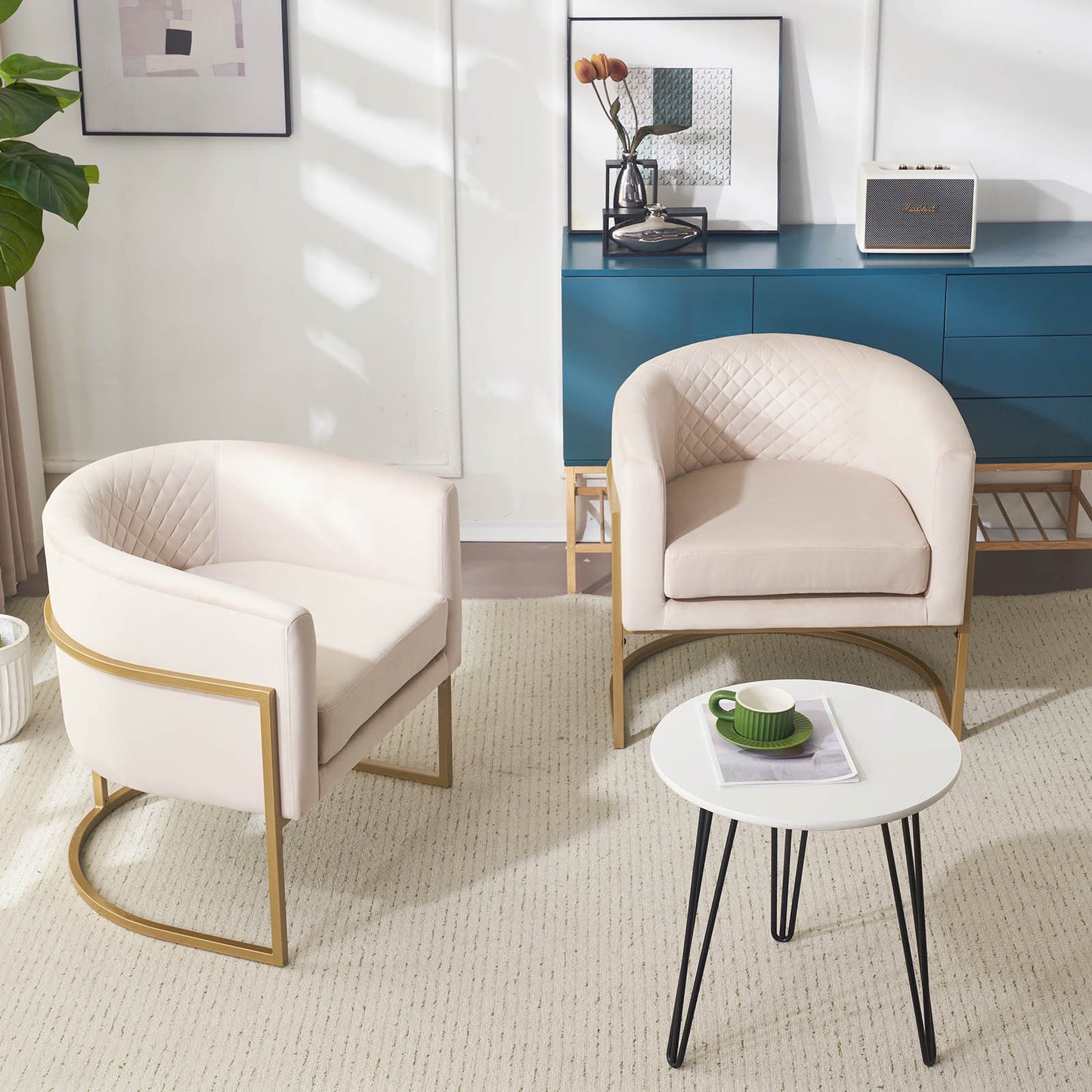 Upholstered barrel chair in cream velvet with diamond tufting and gold metal legs