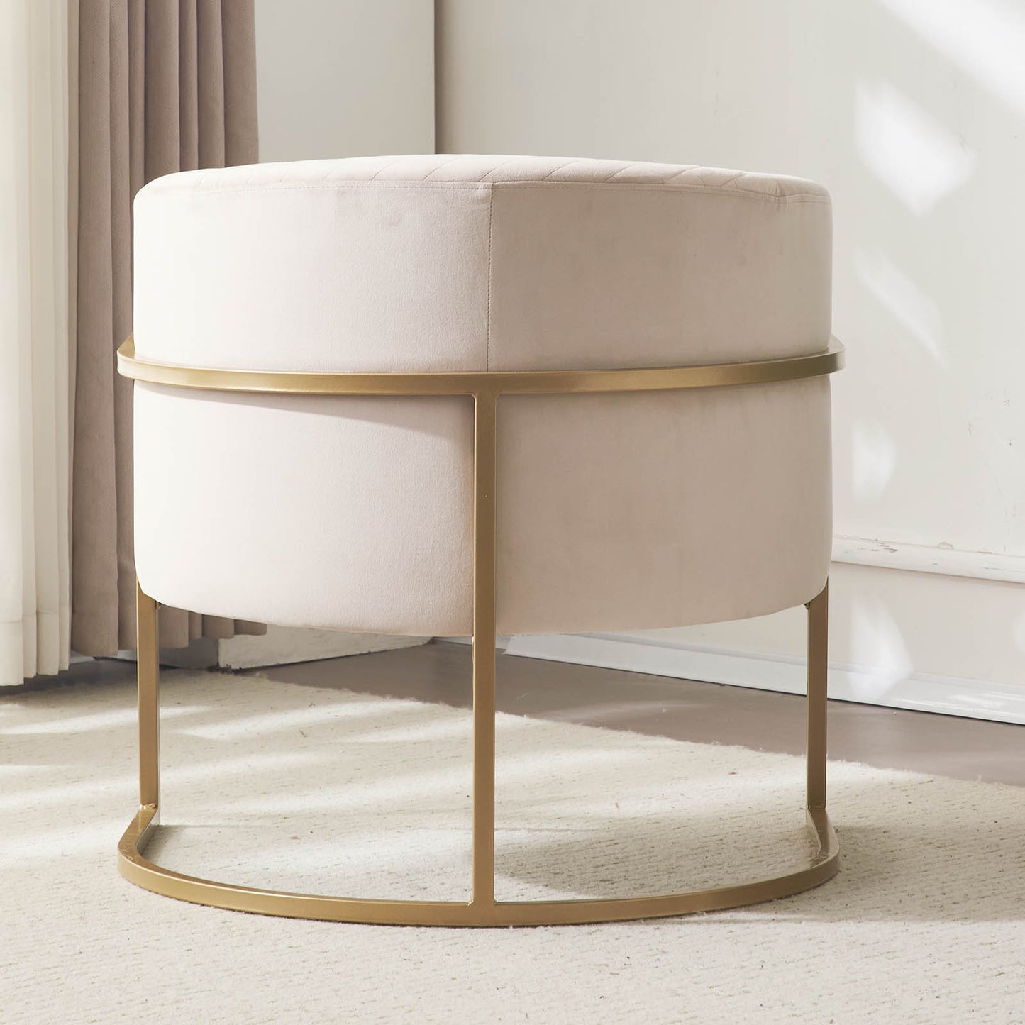 Champagne velvet round ottoman with diamond tufting and gold metal base