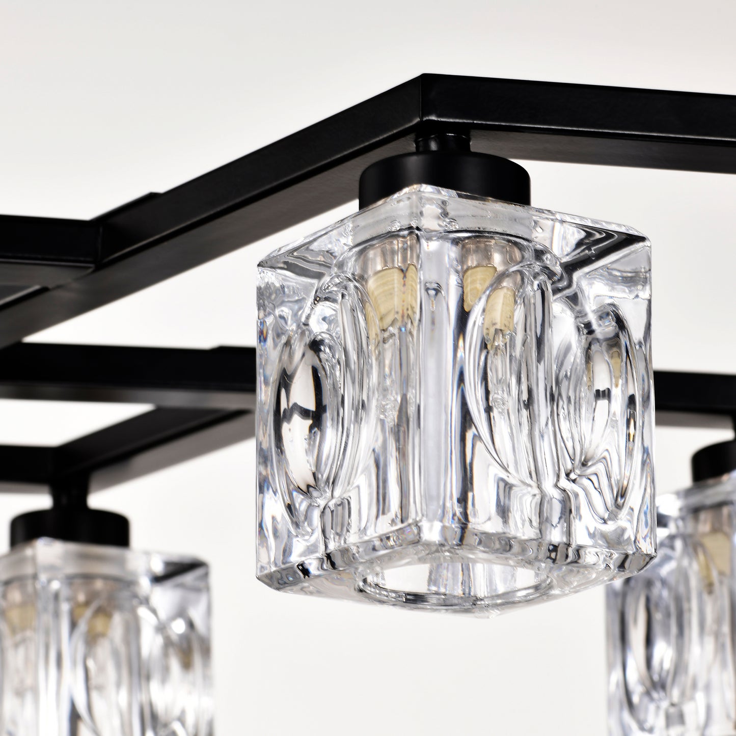 Closeup of a modern black metal chandelier with clear glass cube shades