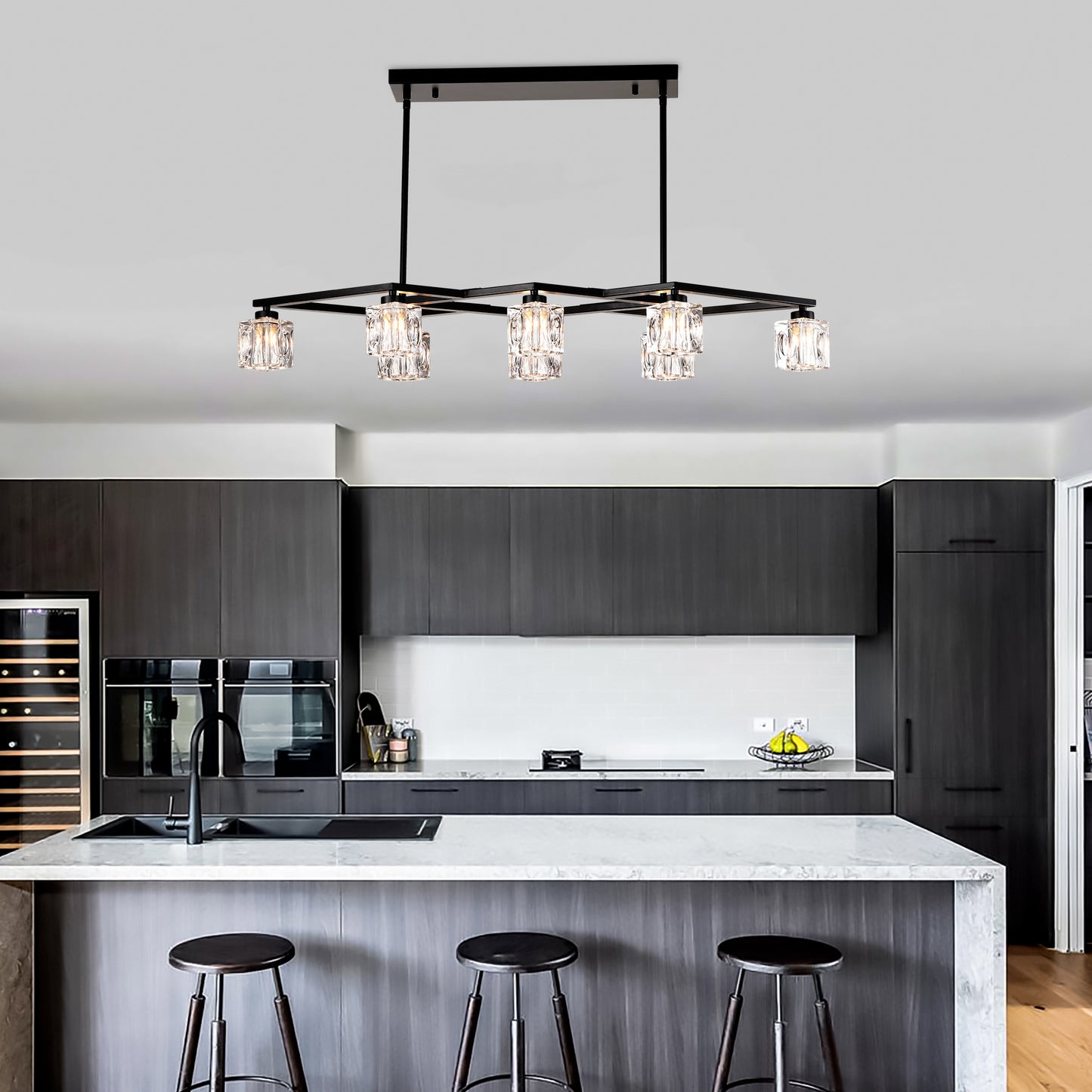 Modern black chandelier with faceted crystal pendant lights illuminating a sleek kitchen island