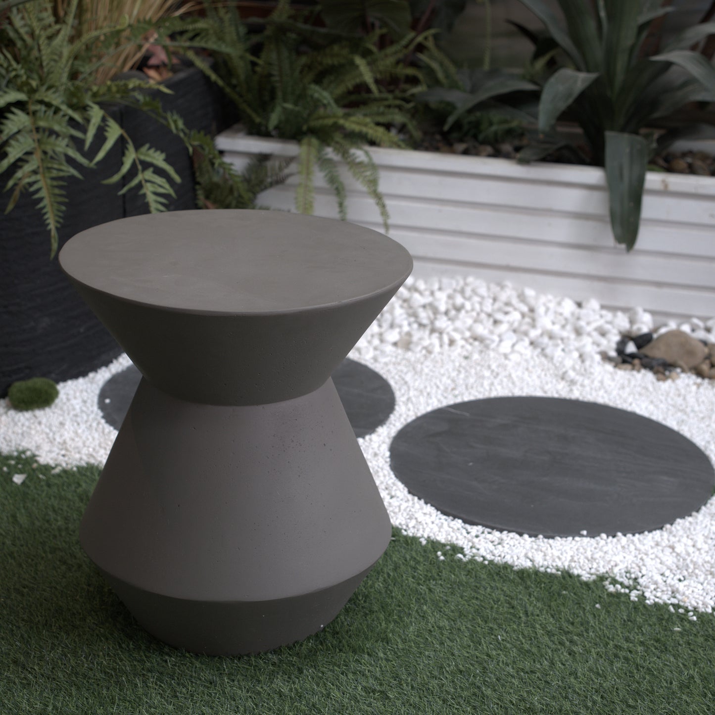 Modern grey hourglass stool made of concrete for outdoor seating