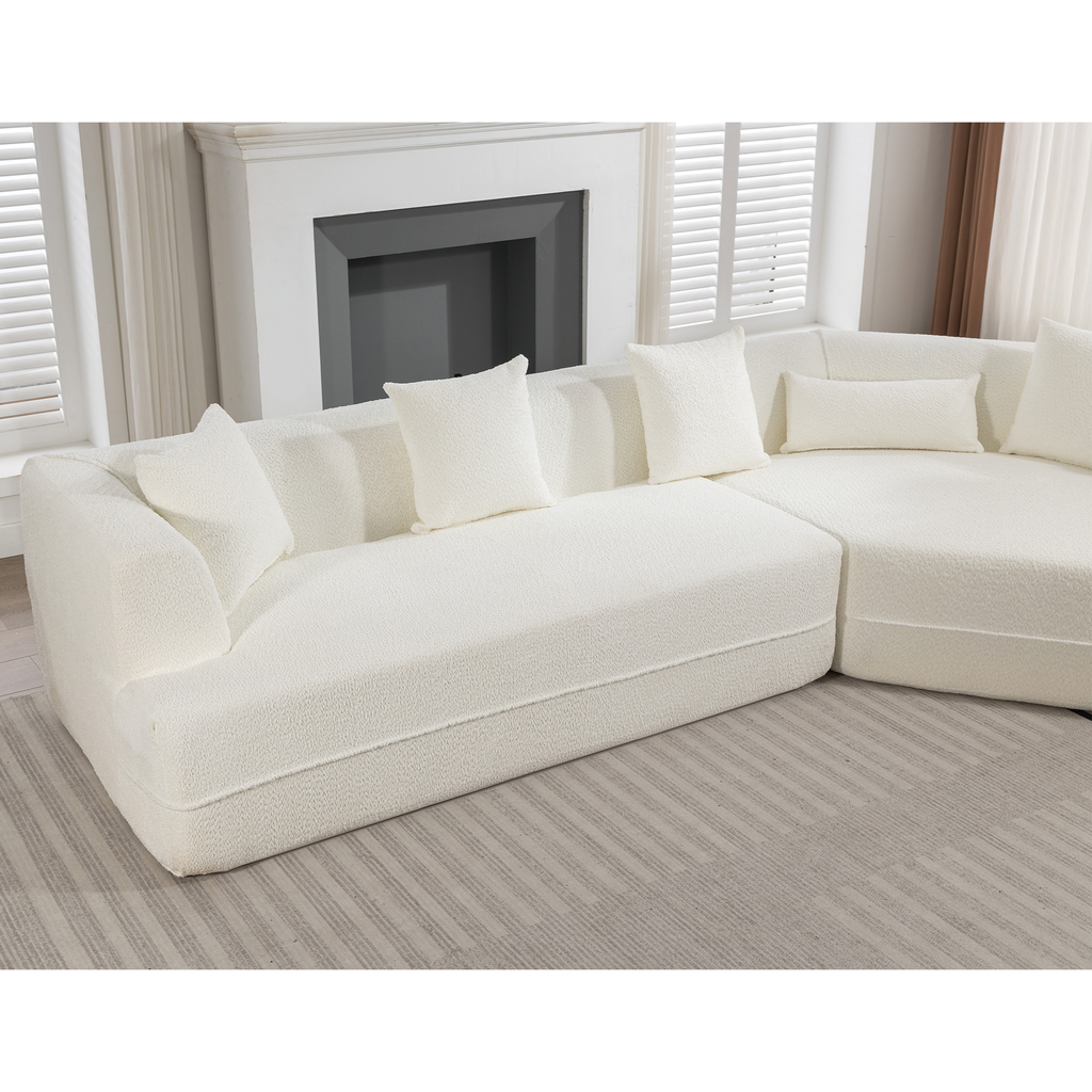 Plush white sectional sofa with modern boucle fabric and matching throw pillows