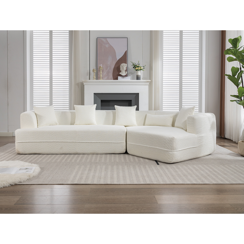 Plush white boucl fabric sectional sofa with multiple throw pillows