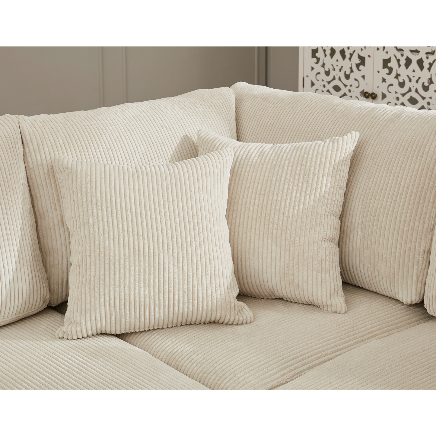 Plush cream corduroy sofa with matching throw pillows for a cozy living room
