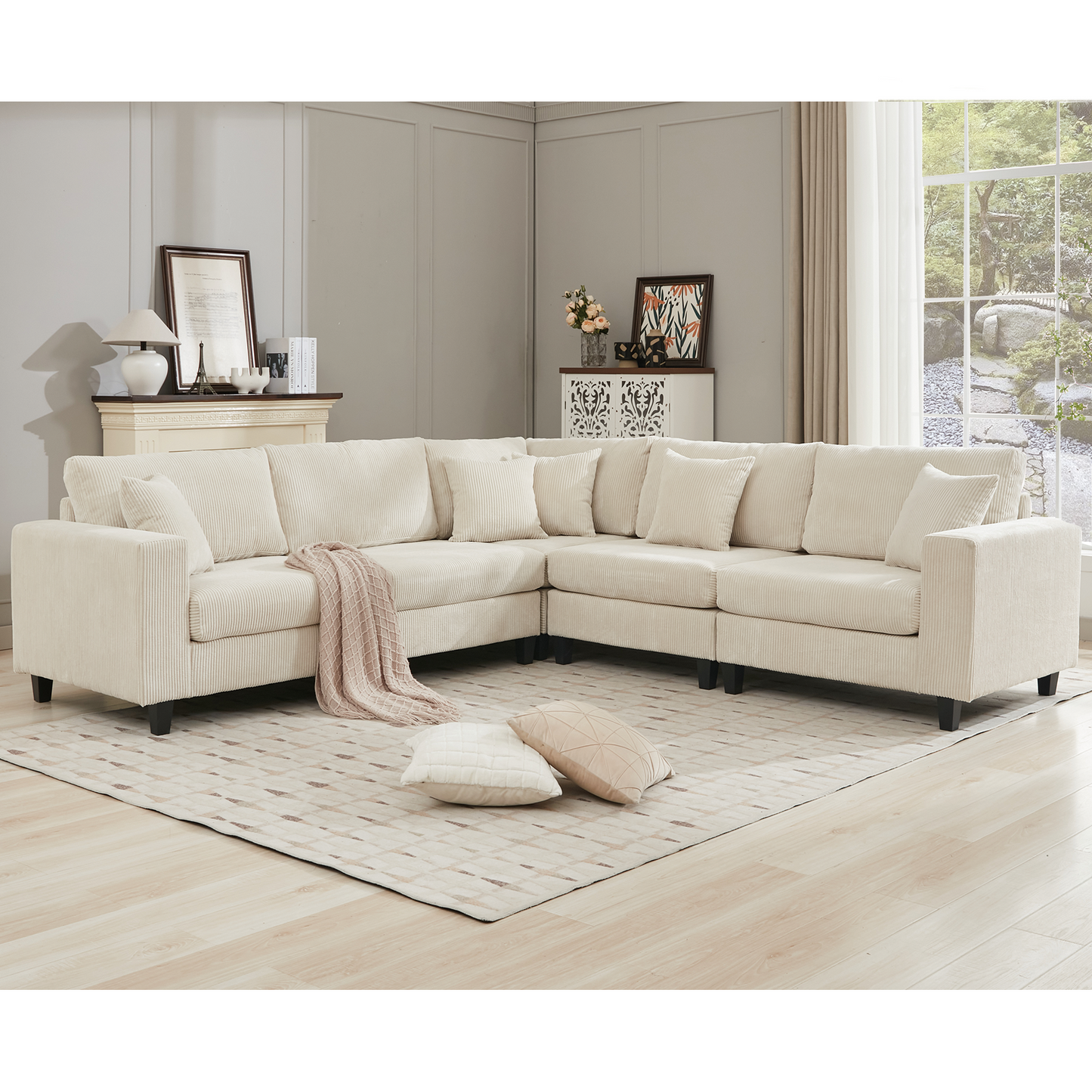 Cream corduroy sectional sofa with plush cushions and a draped throw blanket