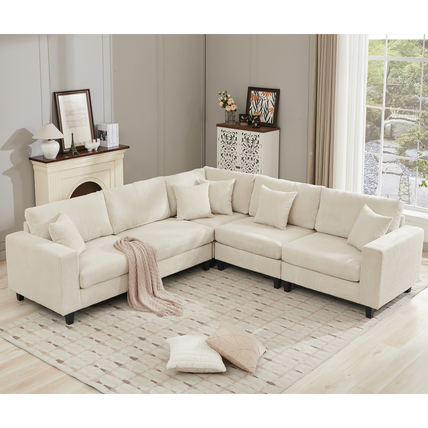 Cream corduroy sectional sofa with plush cushions and a pink throw blanket