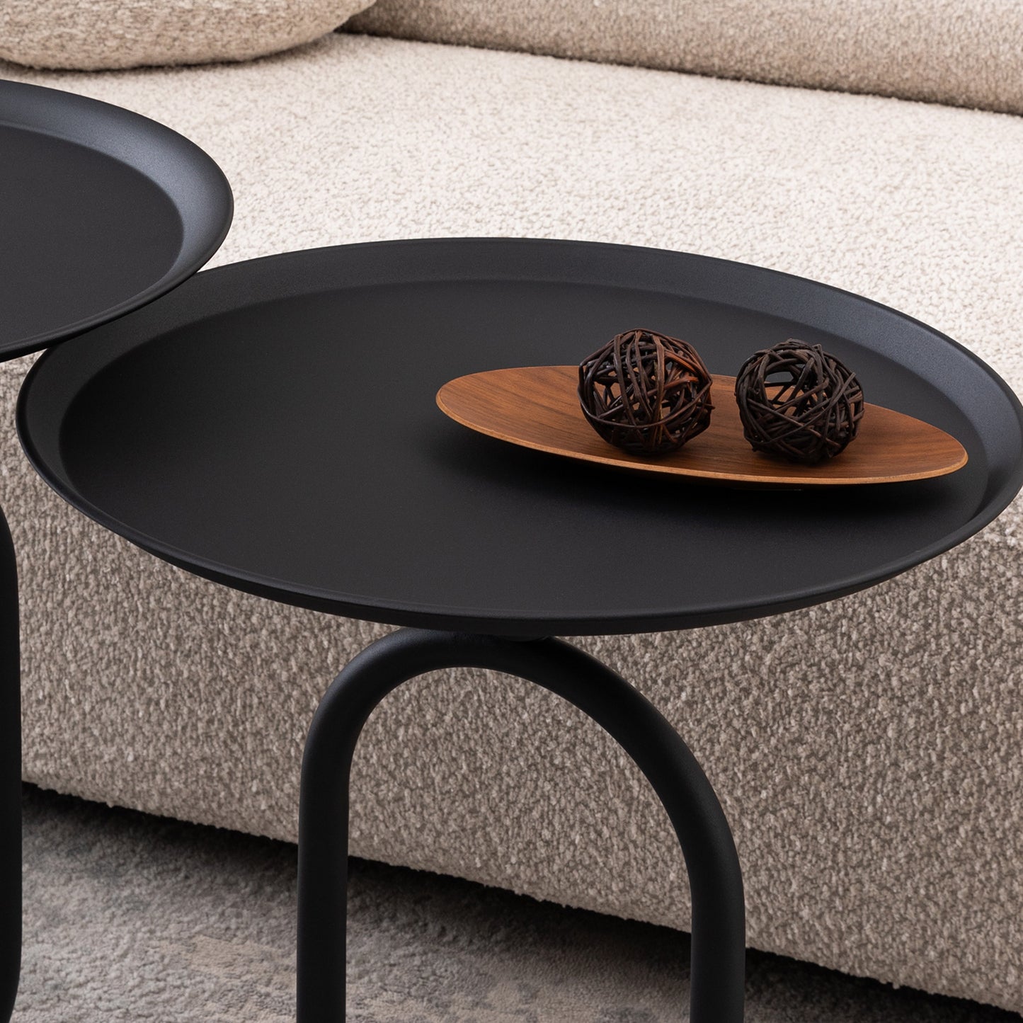 Minimalist black metal side table with organic wooden tray and decorative orbs