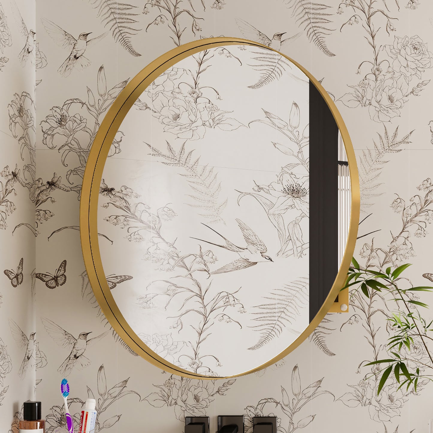 Round goldframed bathroom mirror with floral and bird wallpaper