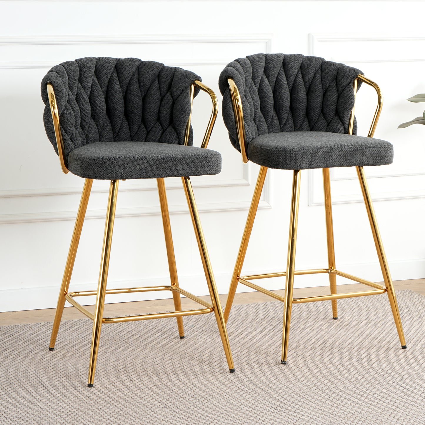 Dark gray tufted bar stools with gold legs perfect for modern kitchens