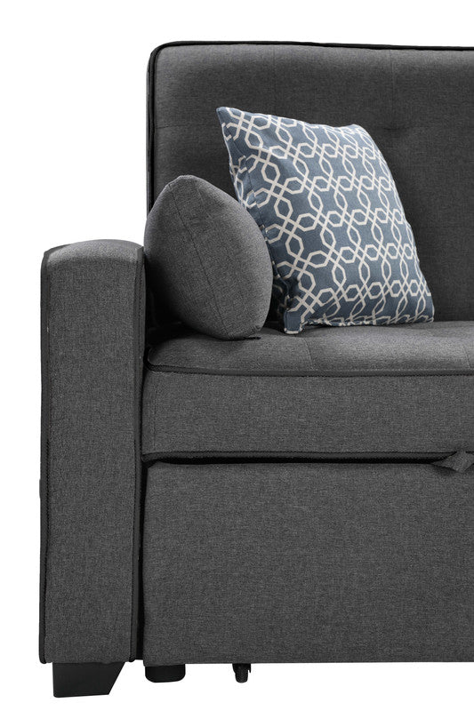 Dark gray fabric sofa with a blue geometric pattern throw pillow and a round gray pillow