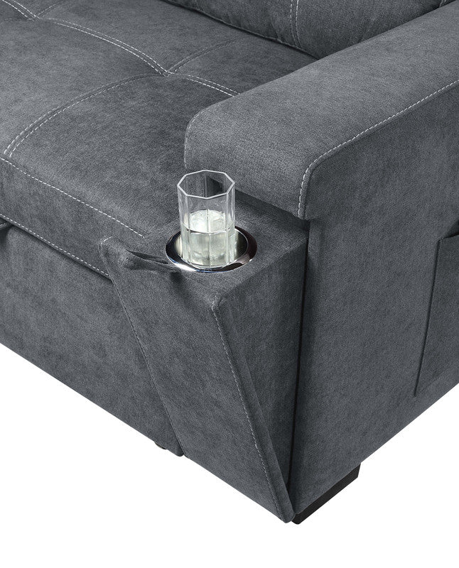 Dark gray fabric armchair with builtin cupholder and glass of water