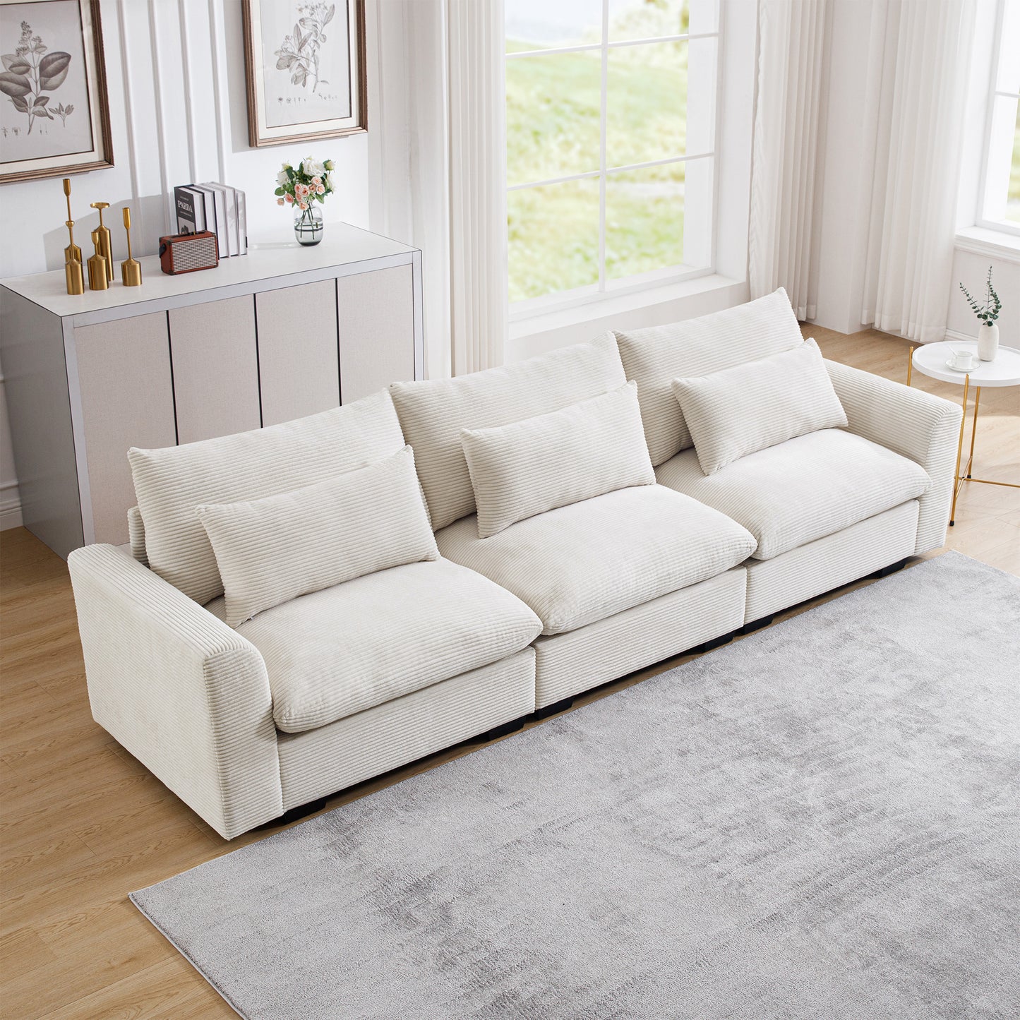 Cream corduroy sectional sofa with plush pillows in a modern living room setting