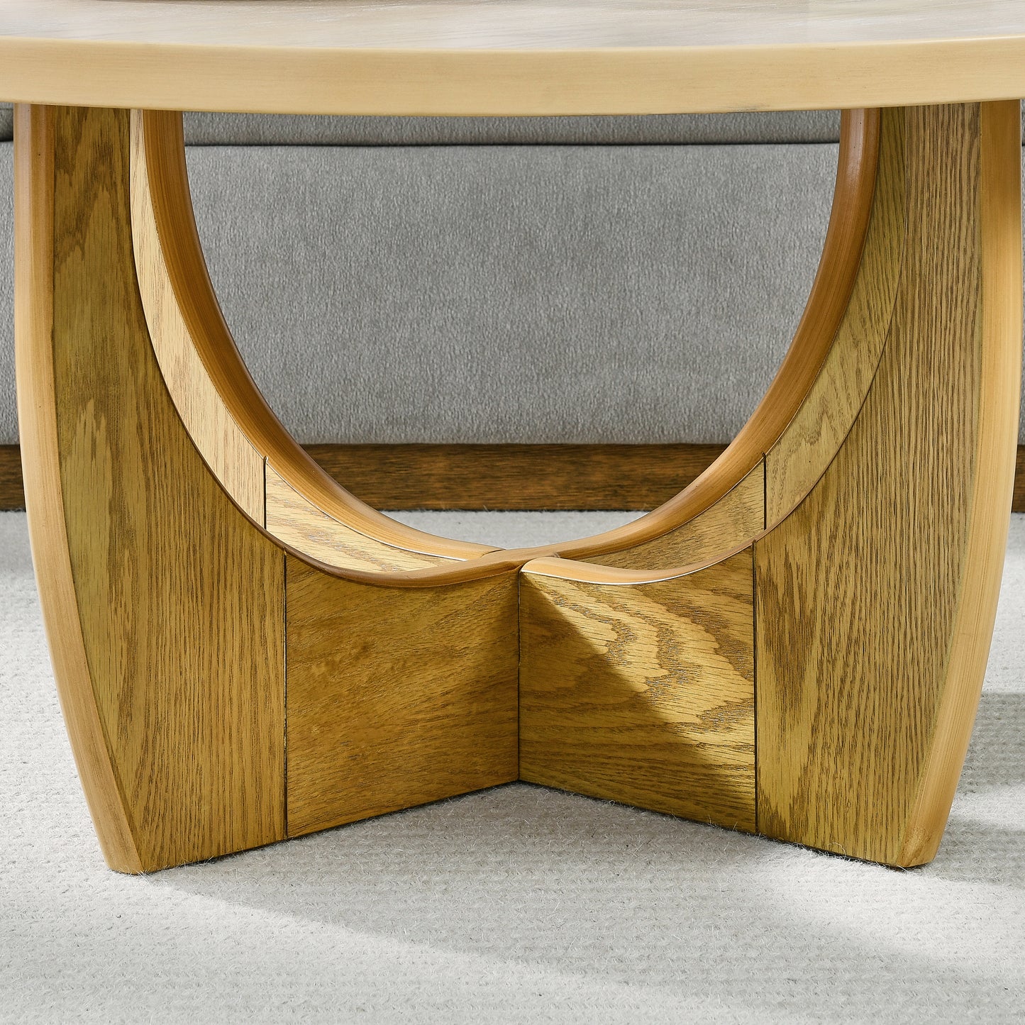 Midcentury modern oak coffee table base with curved wood legs and a light wood finish