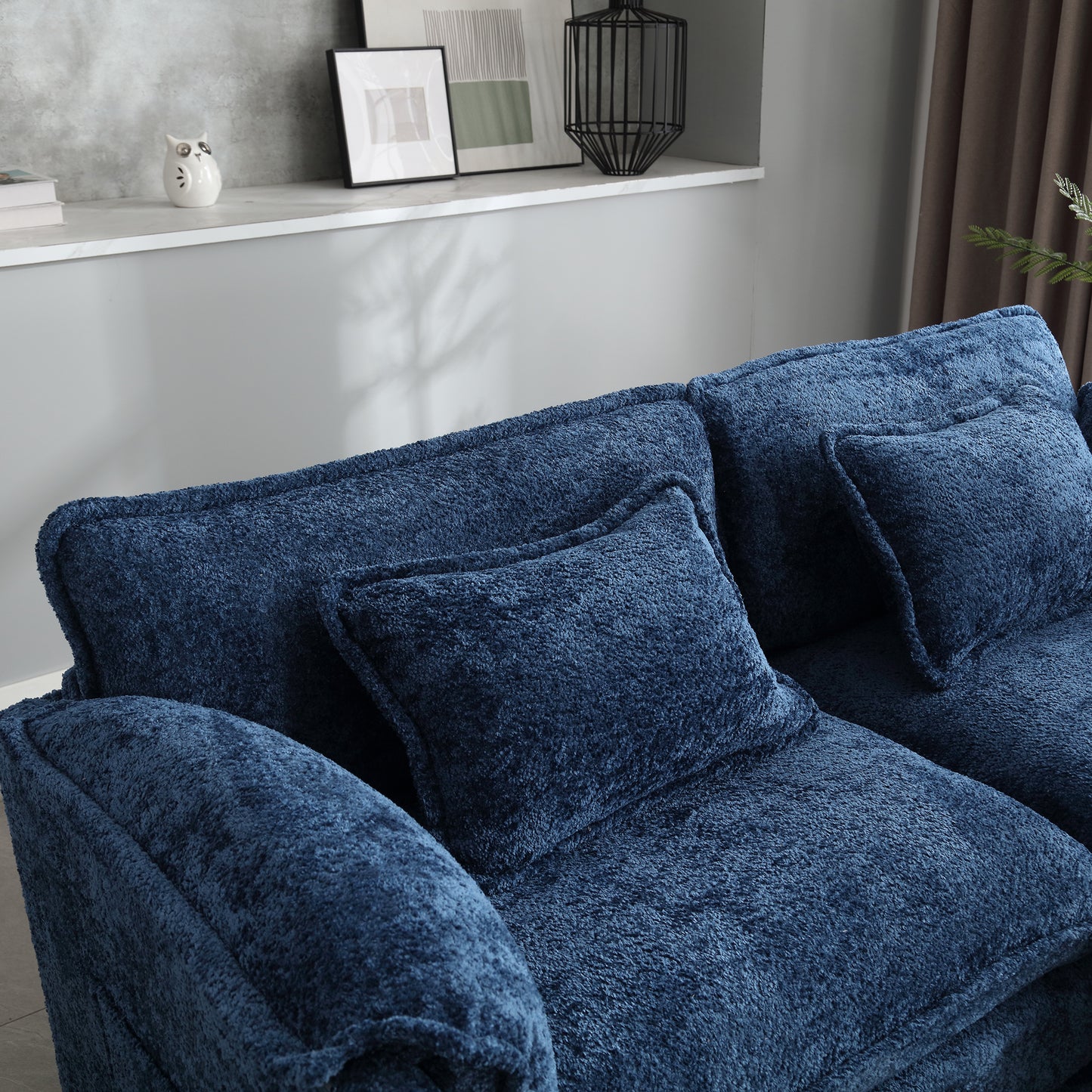 Plush navy blue sofa with textured fabric and deep seat cushions