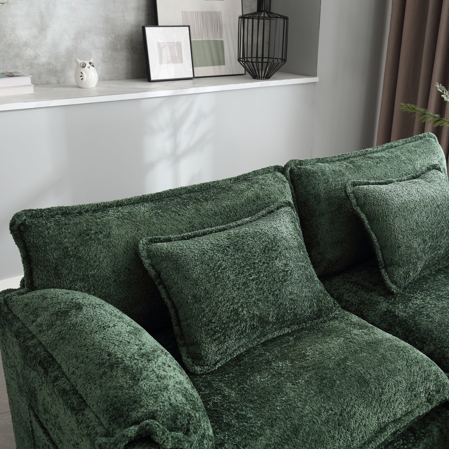 Plush dark green velvet sofa with deep seat cushions and accent pillows for ultimate comfort