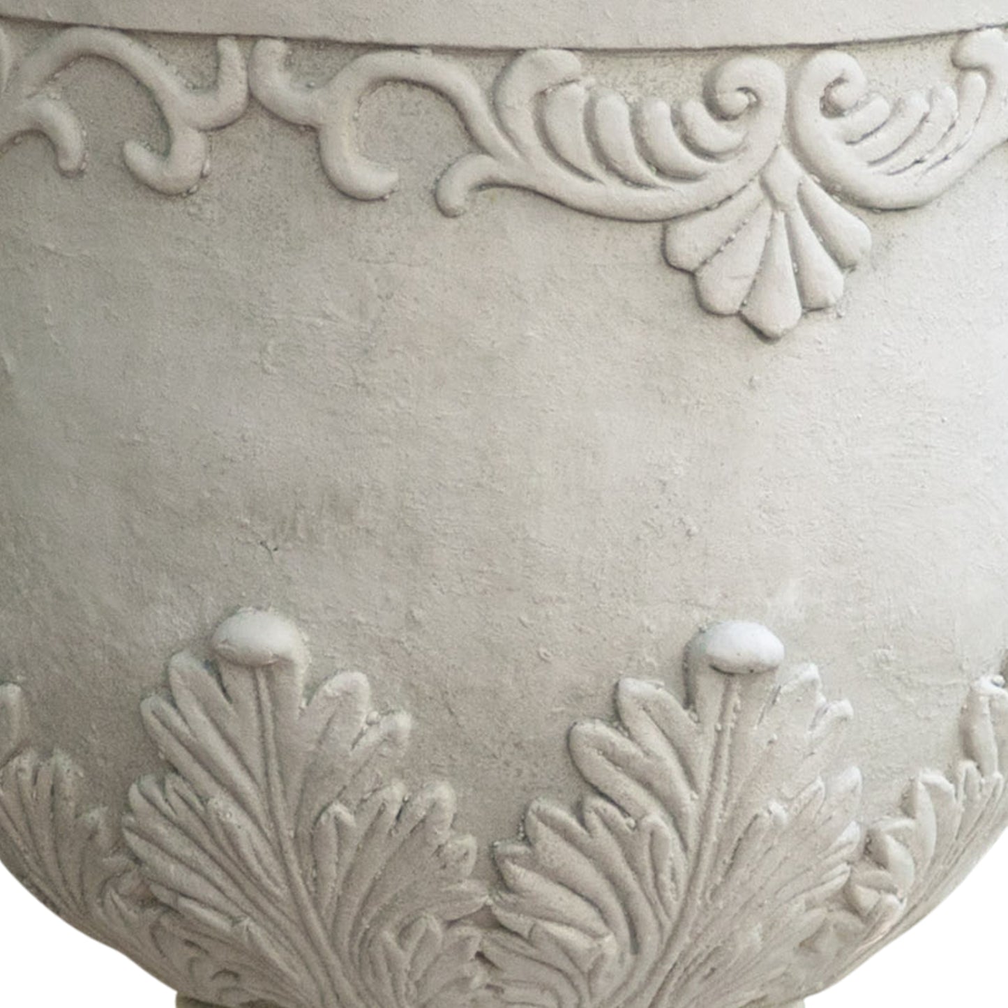 Textured grey ceramic planter with ornate scrollwork and leaf motifs for outdoor gardens