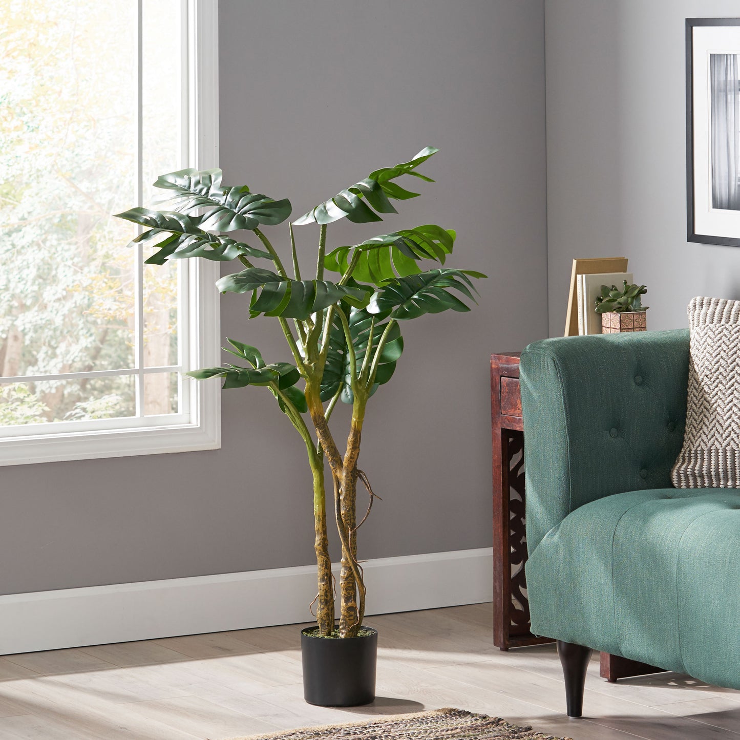 Tall artificial Monstera plant with lush green leaves in a black pot ideal for home decor