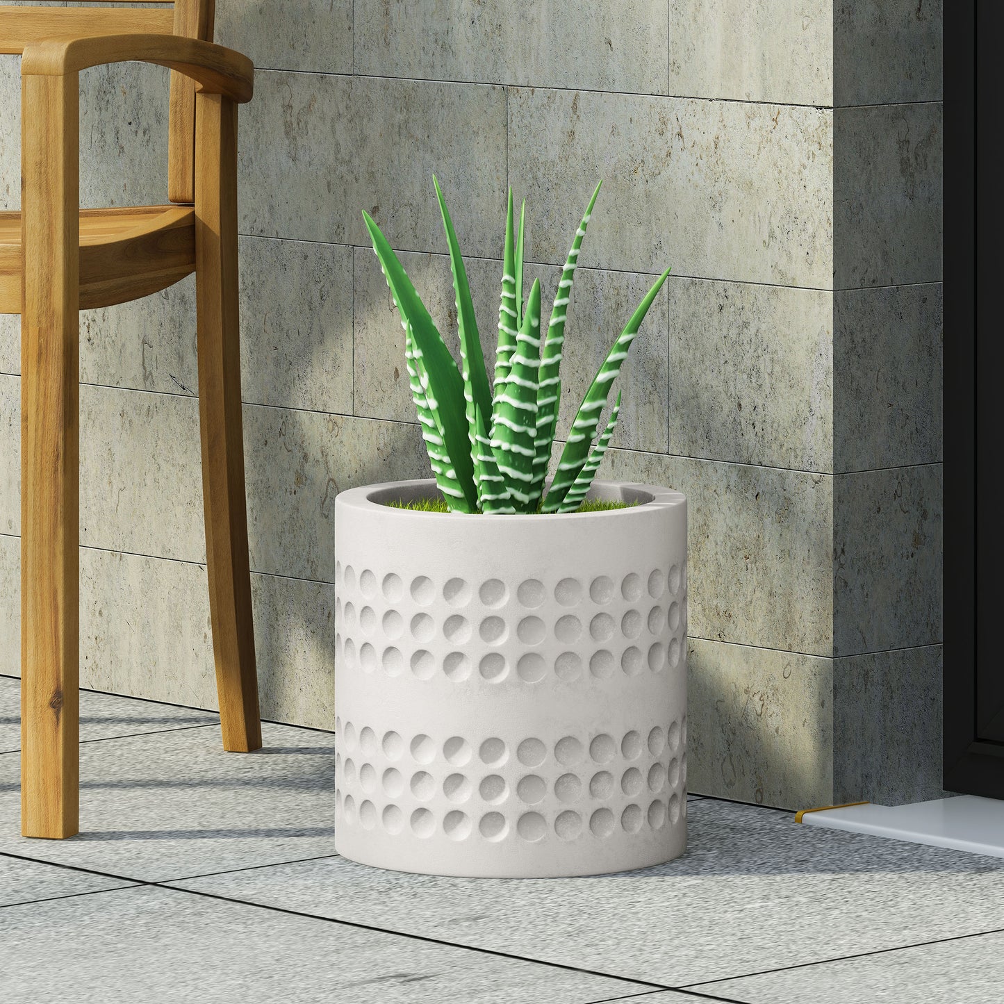 White textured planter with a zebra plant in a modern outdoor setting