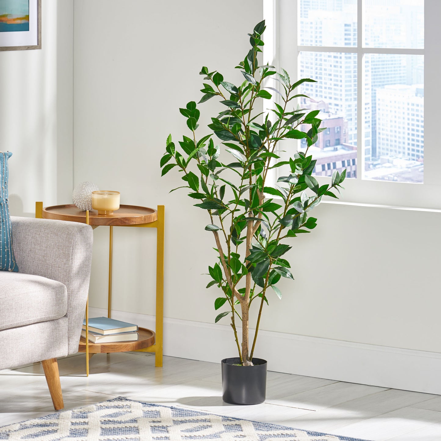 Tall faux olive tree with realistic green leaves in a black pot perfect for indoor decor