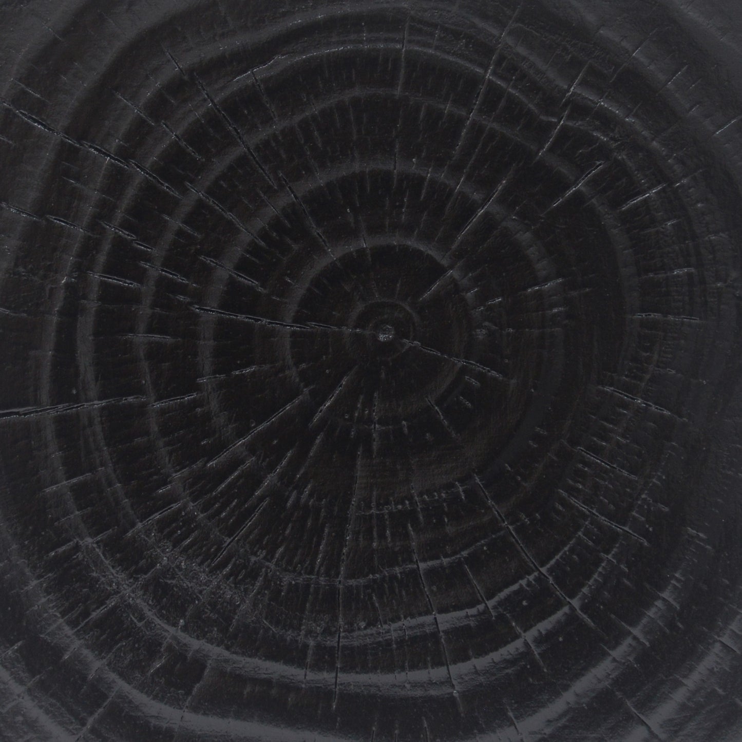 Dark wood grain texture with visible growth rings and subtle cracks