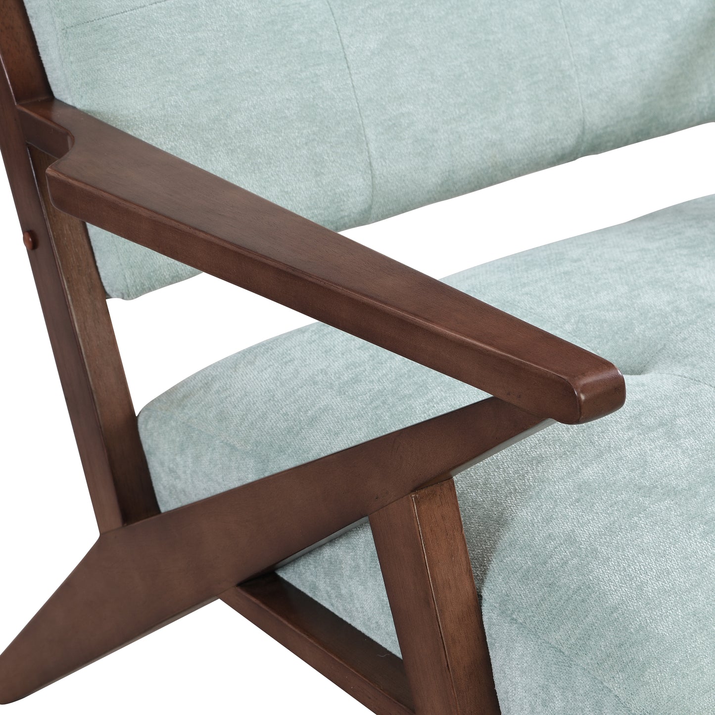Closeup of a light blue fabric armchair with a dark wood armrest