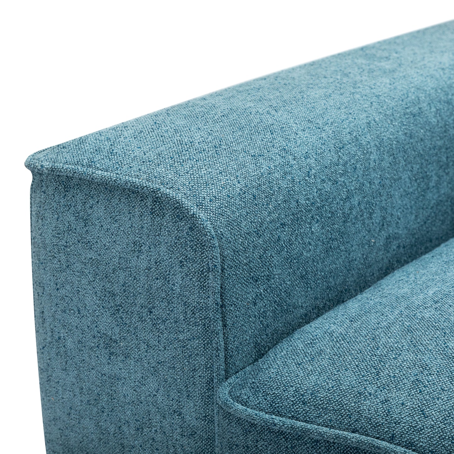 Closeup of a textured teal fabric couch armrest with clean stitching for modern living
