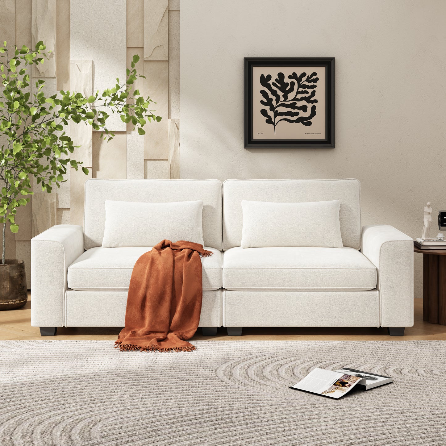 Cream boucle sofa with orange throw blanket on textured rug