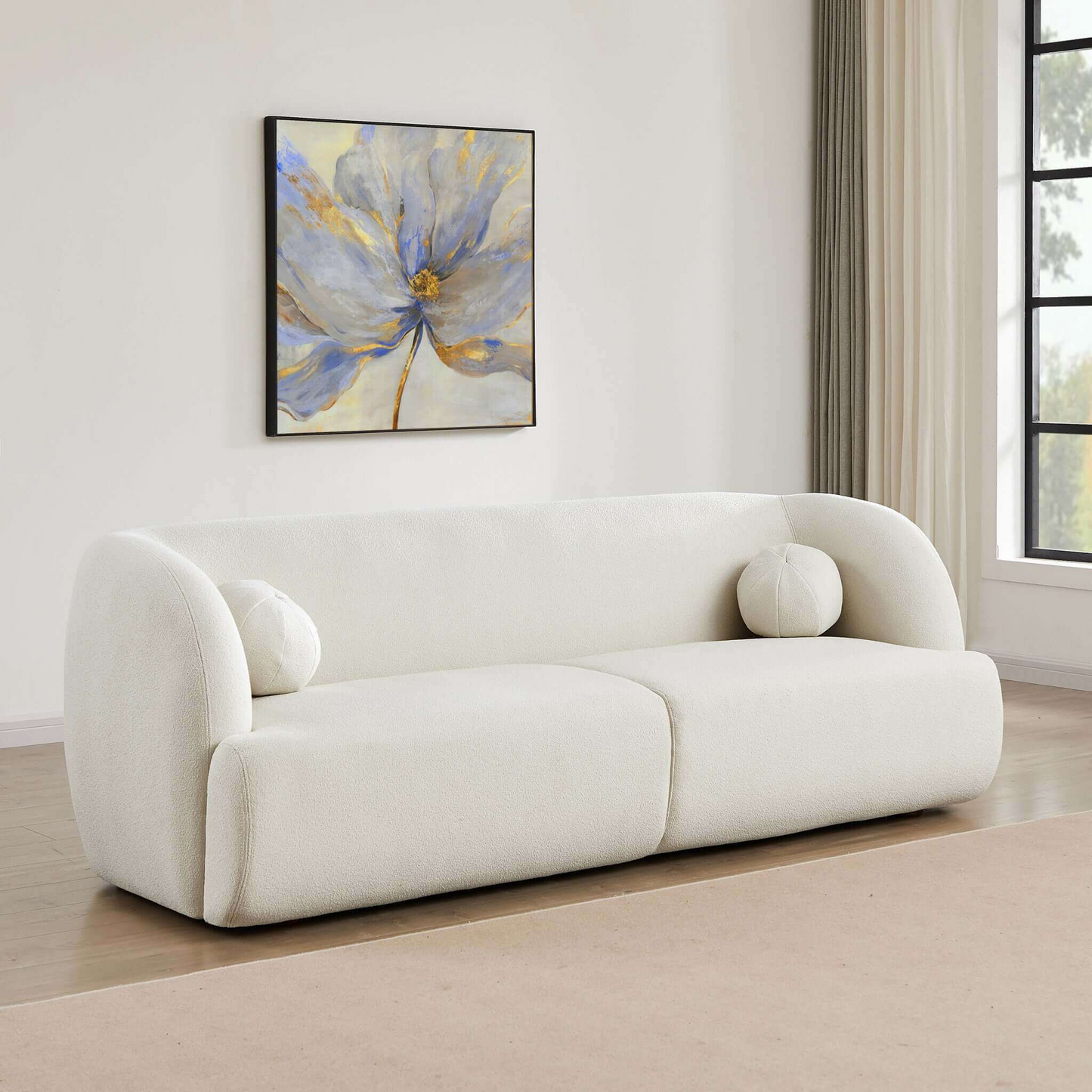 Plush white boucle sofa with rounded arms and two circular accent pillows perfect for modern living rooms