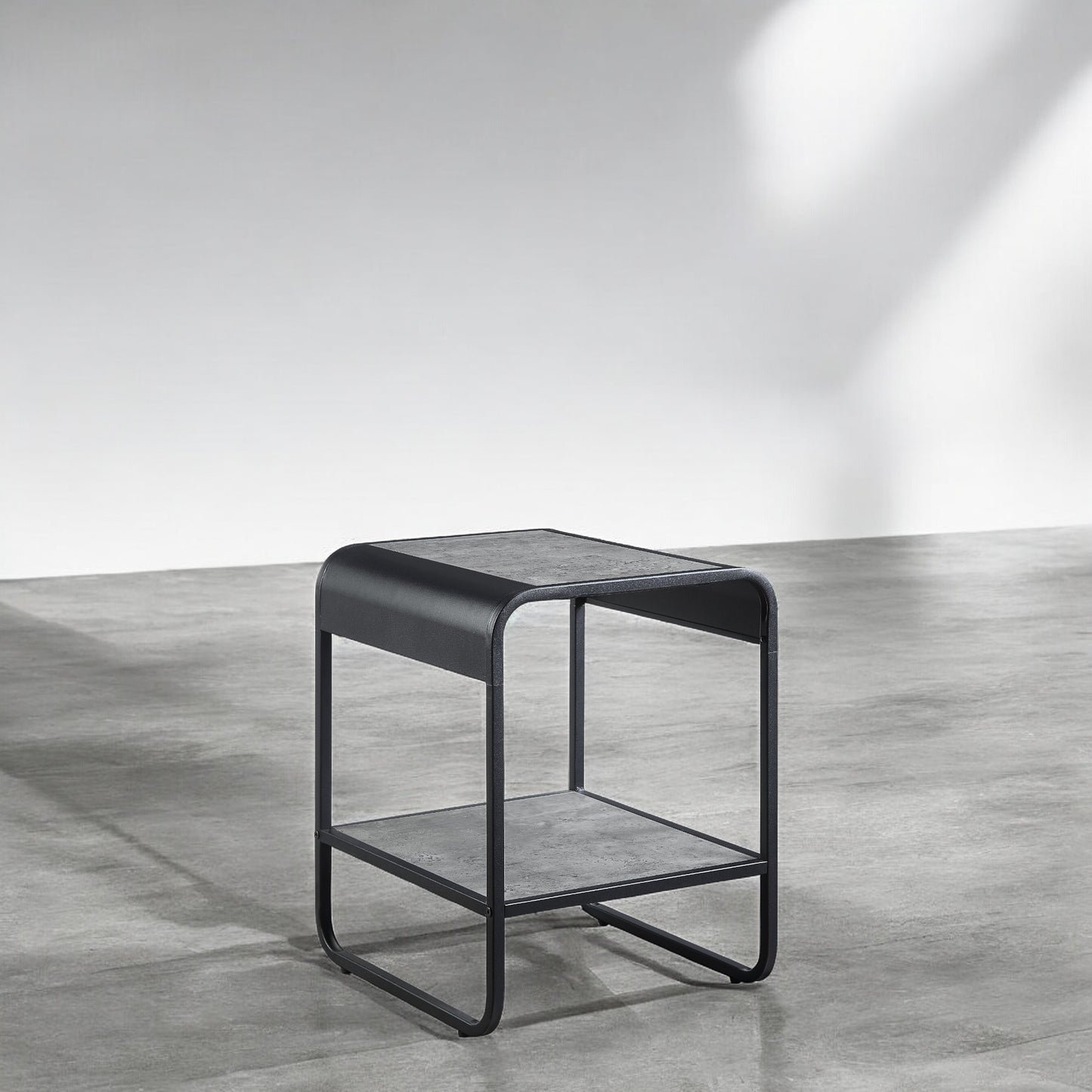 Modern black metal side table with grey faux concrete top and shelf