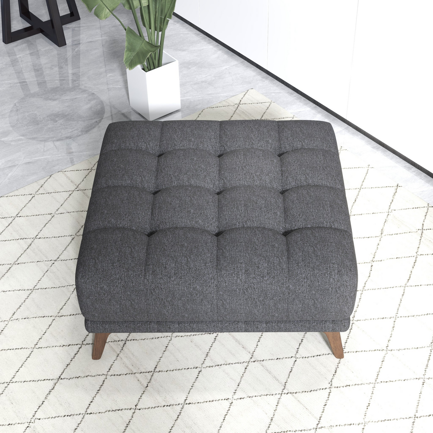 Tufted charcoal grey fabric ottoman with button tufting and wooden legs