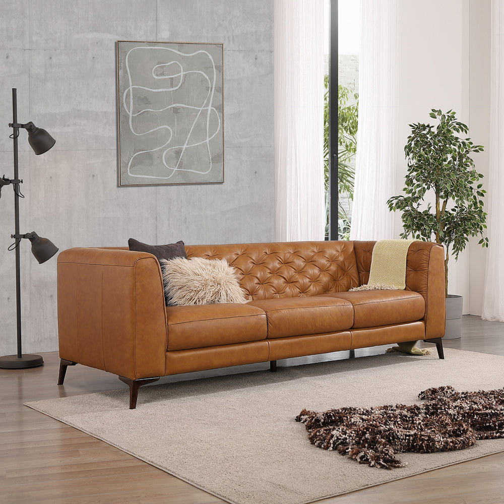 Tan leather tufted sofa with plush cushions and modern design