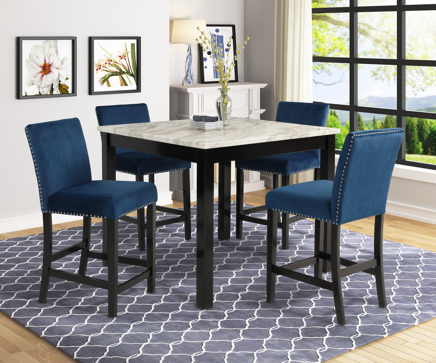 Four navy blue velvet bar stools with silver nailhead trim surround a faux marble top bar table