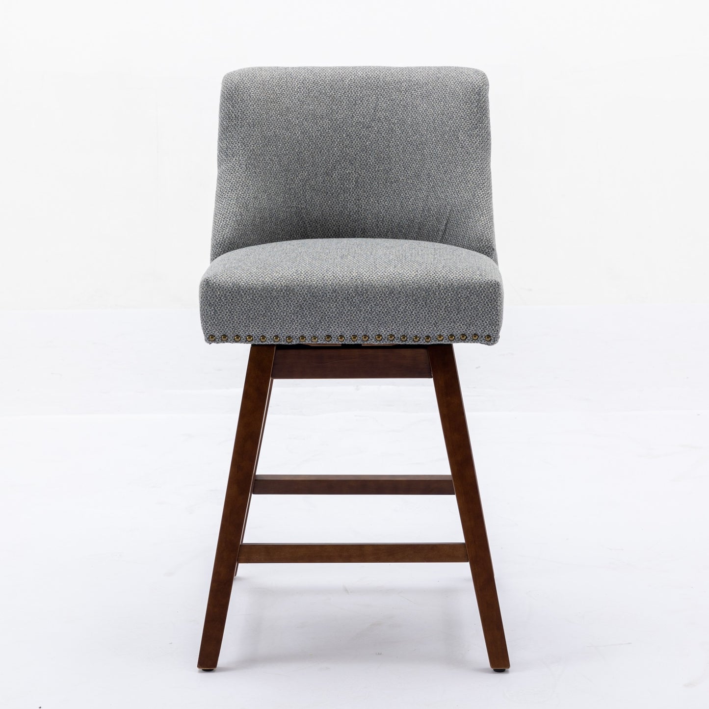Grey upholstered swivel bar stool with nailhead trim and dark wood legs