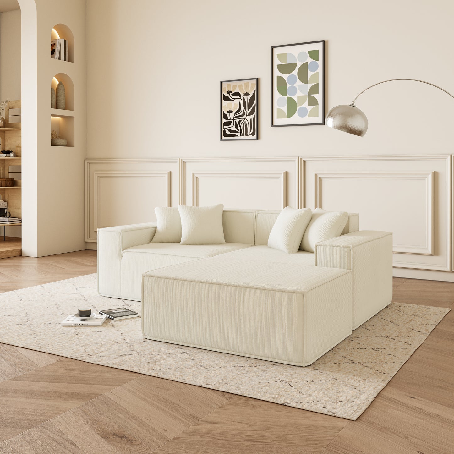 Cream fabric modular sectional sofa with matching ottoman on a textured rug