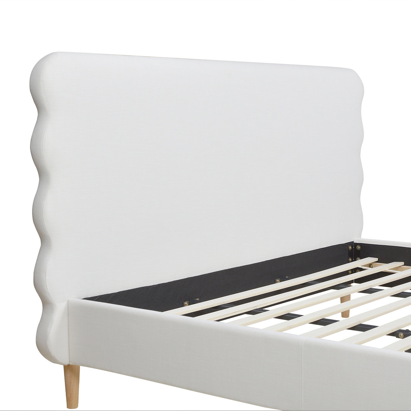 White upholstered bed frame with scalloped headboard and wooden slats