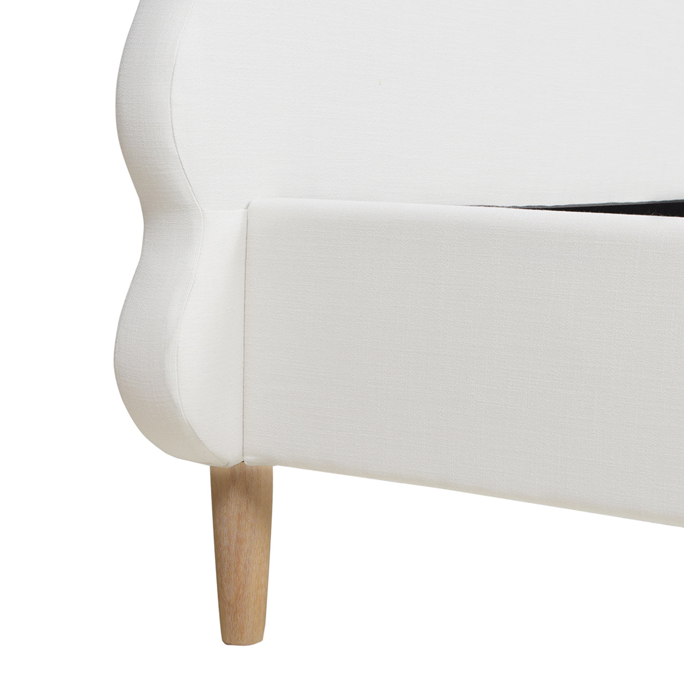 Curved white upholstered bed frame with angled wooden leg