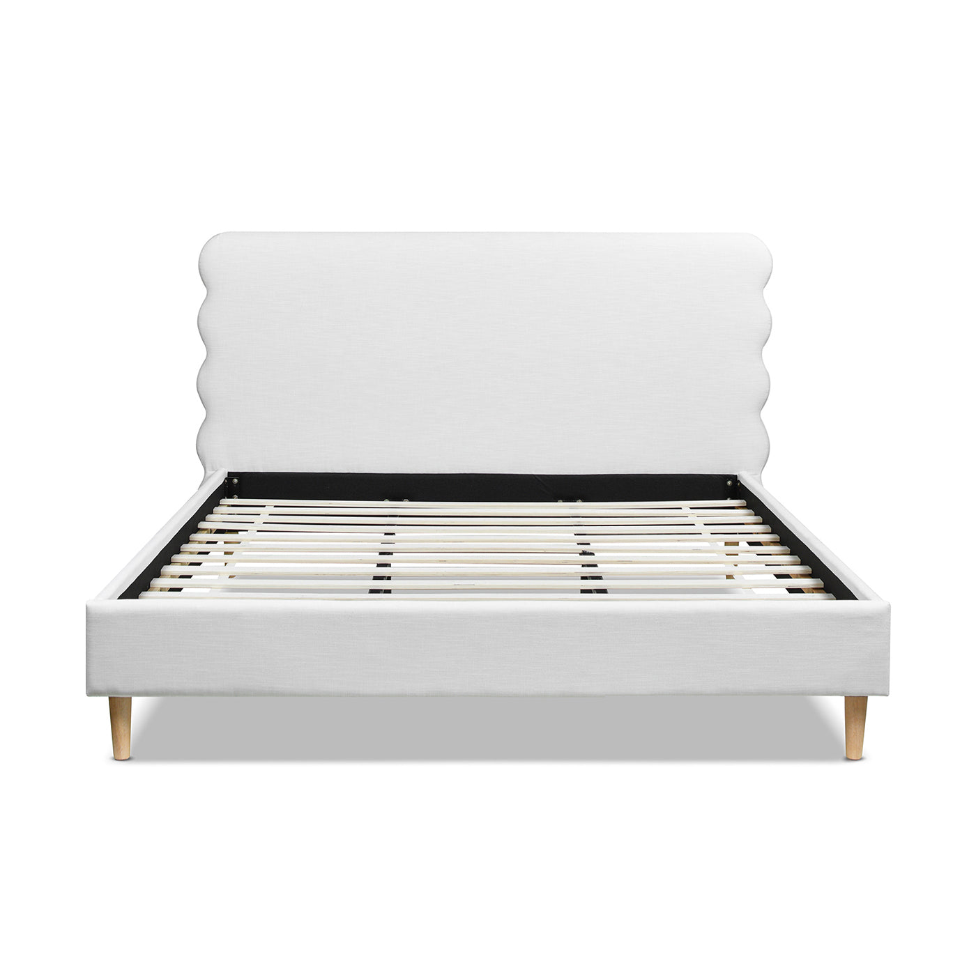 White upholstered bed frame with scalloped headboard and wooden legs