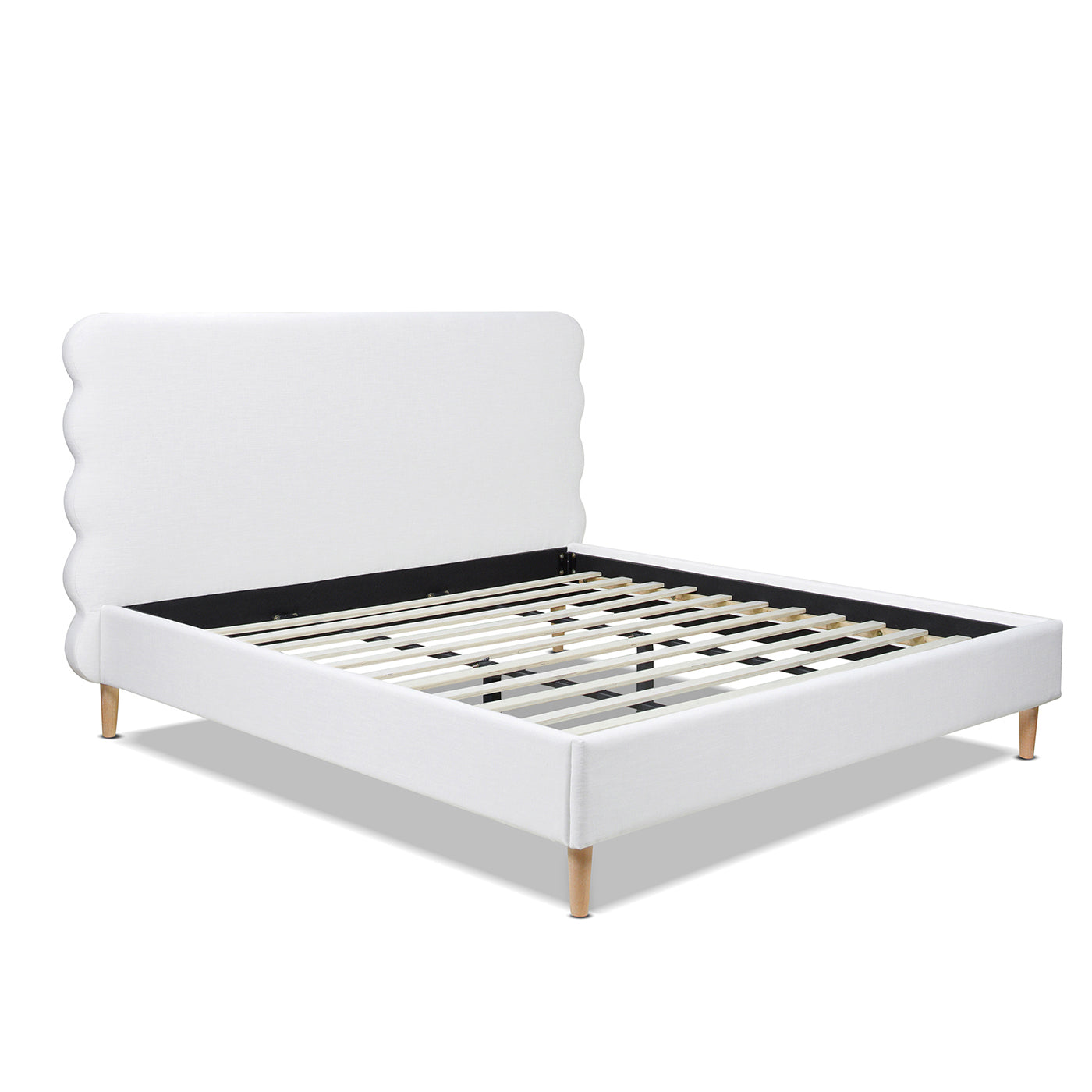 White upholstered king bed frame with scalloped headboard and wooden slats
