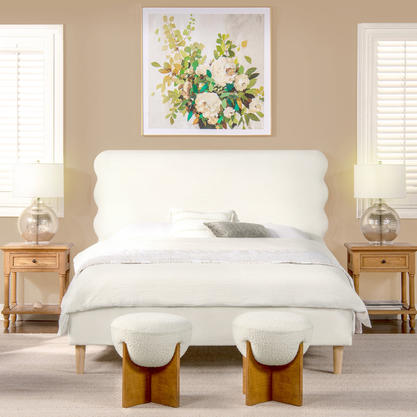 White scalloped headboard bed with plush white bedding and decorative pillows