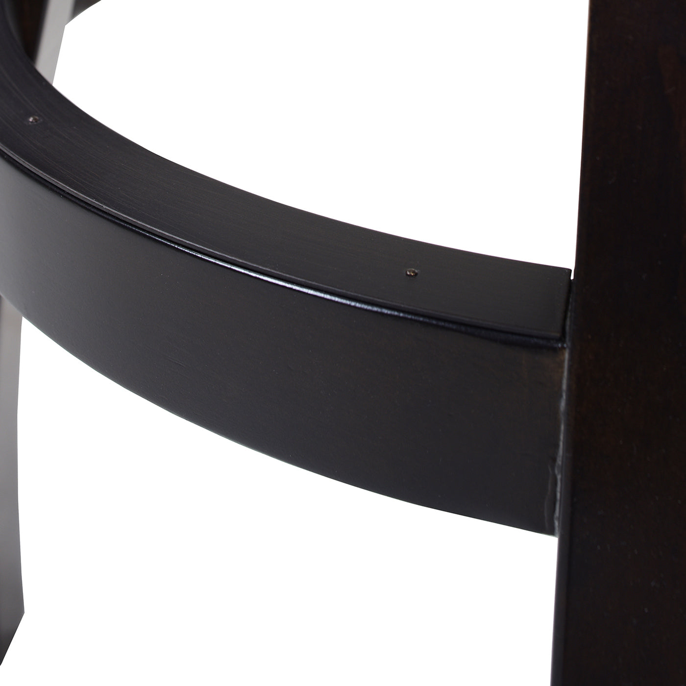Closeup of dark wood curved support on modern accent chair