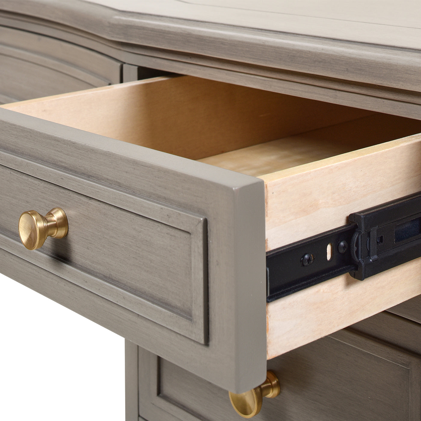 Gray wood desk with one open drawer and brass hardware