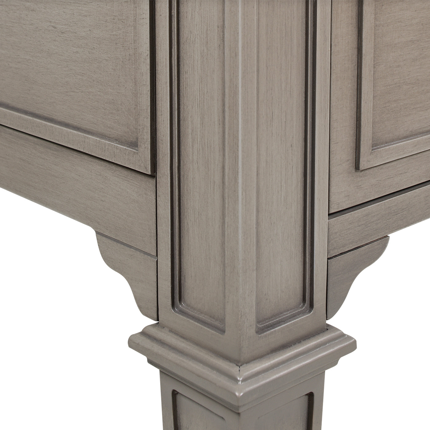Detailed view of carved gray wood dresser leg and frame