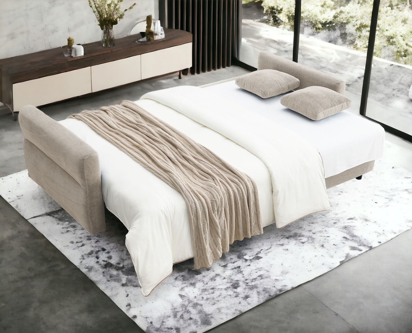 Beige fabric sofa bed with white bedding and a chunky knit throw blanket