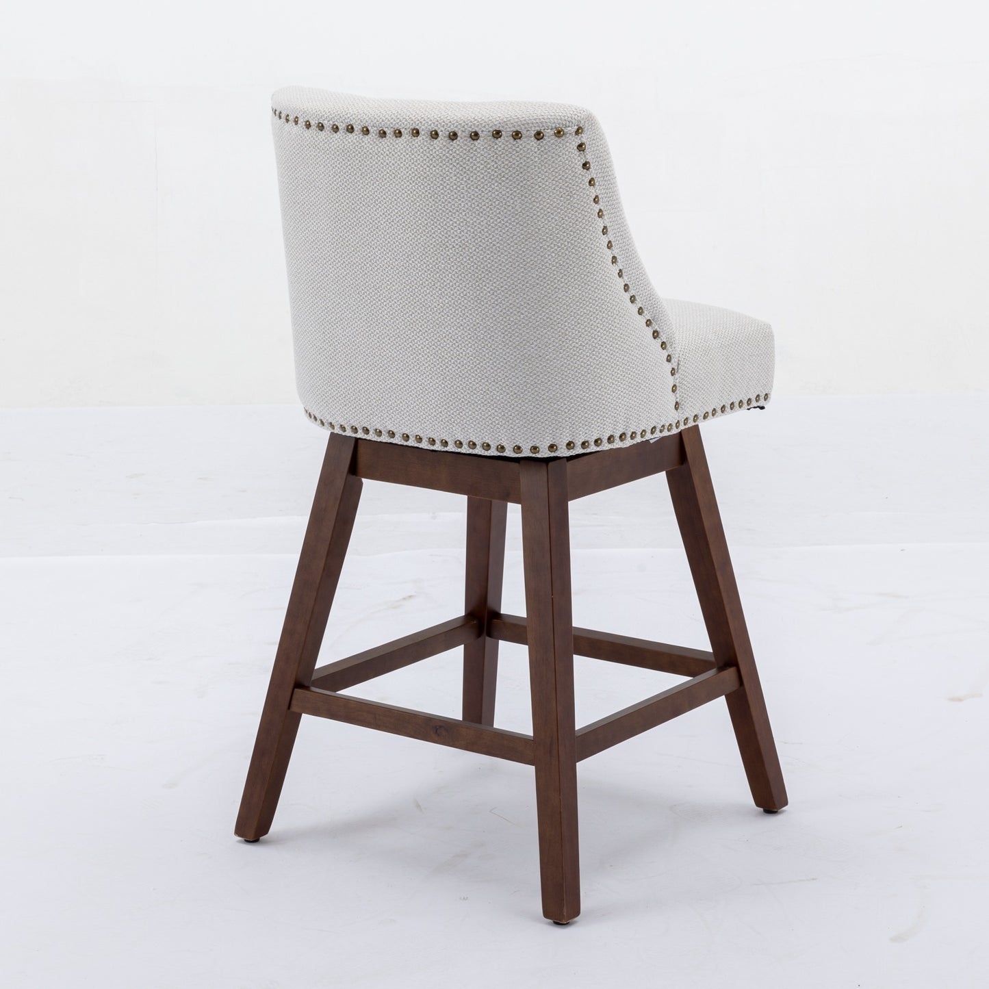 Upholstered swivel bar stool with light gray textured fabric and nailhead trim