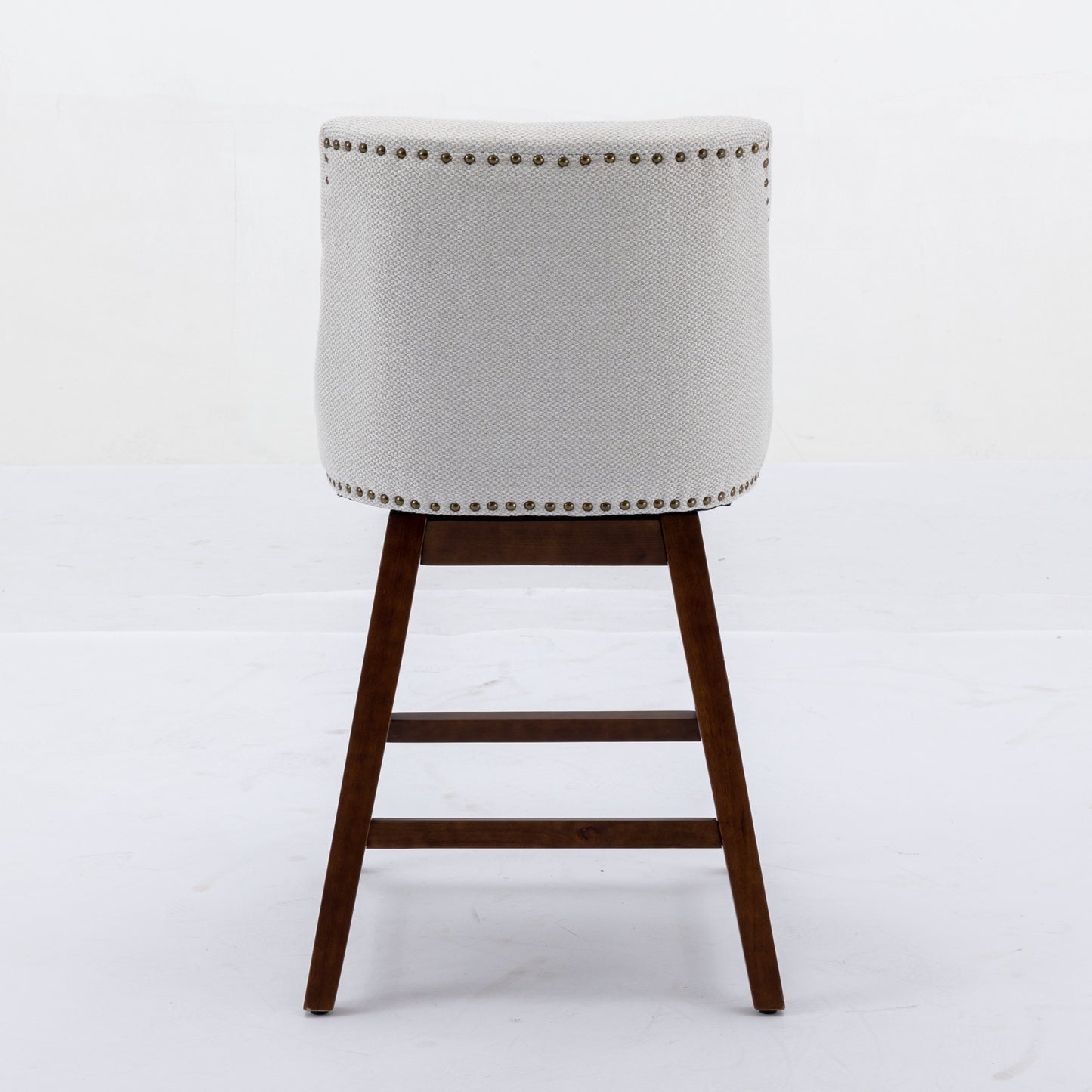 Light gray fabric bar stool with nailhead trim and dark wood legs
