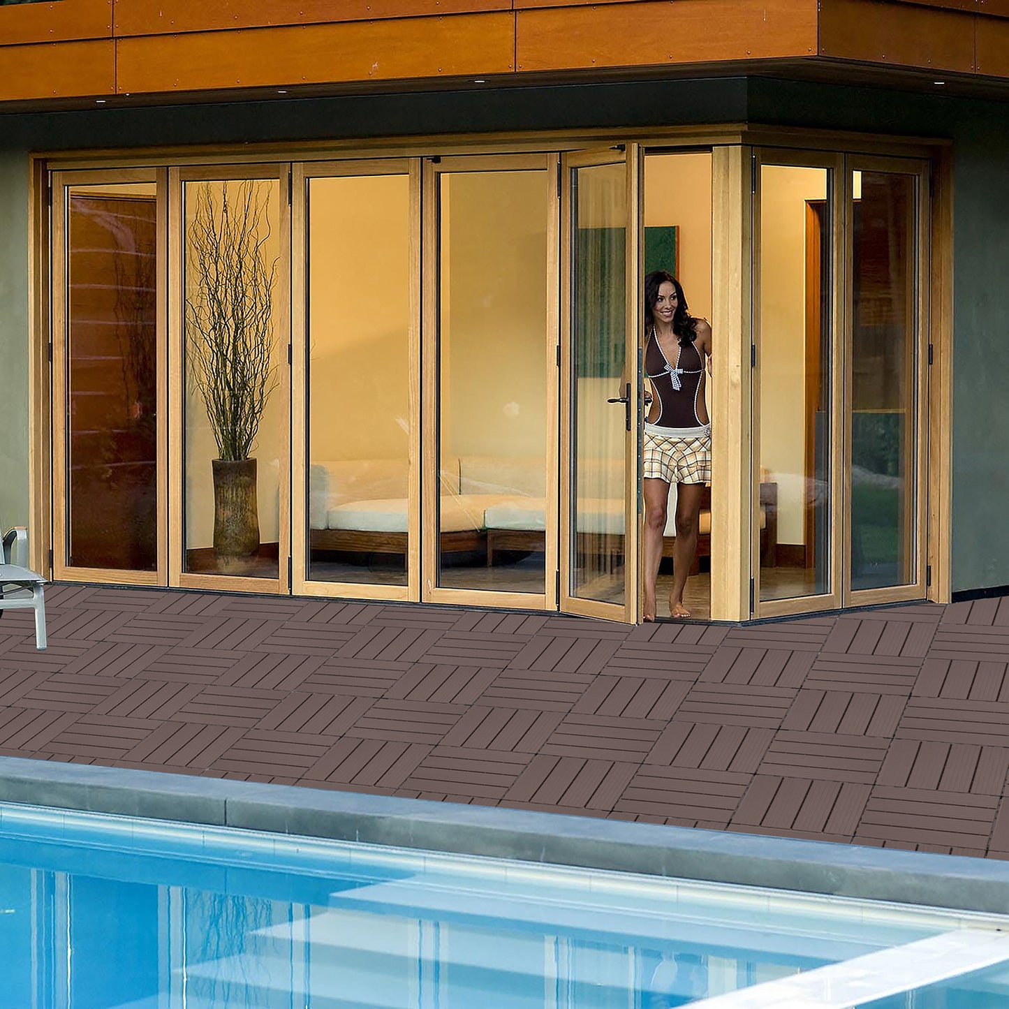 Dark brown interlocking deck tiles for outdoor patios creating a clean poolside area