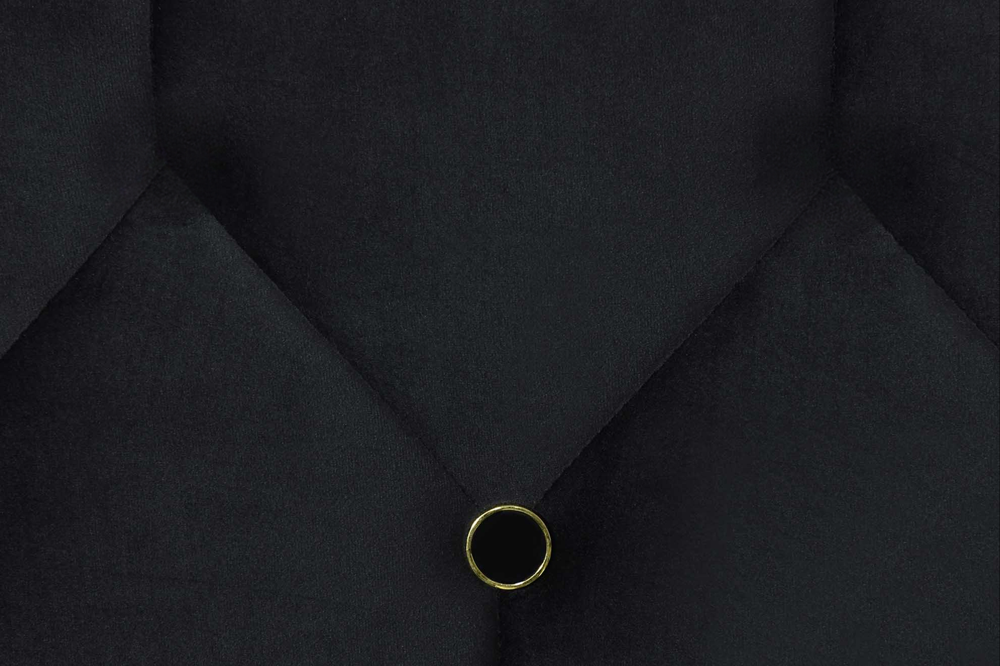 Black velvet tufted headboard detail with gold button accent