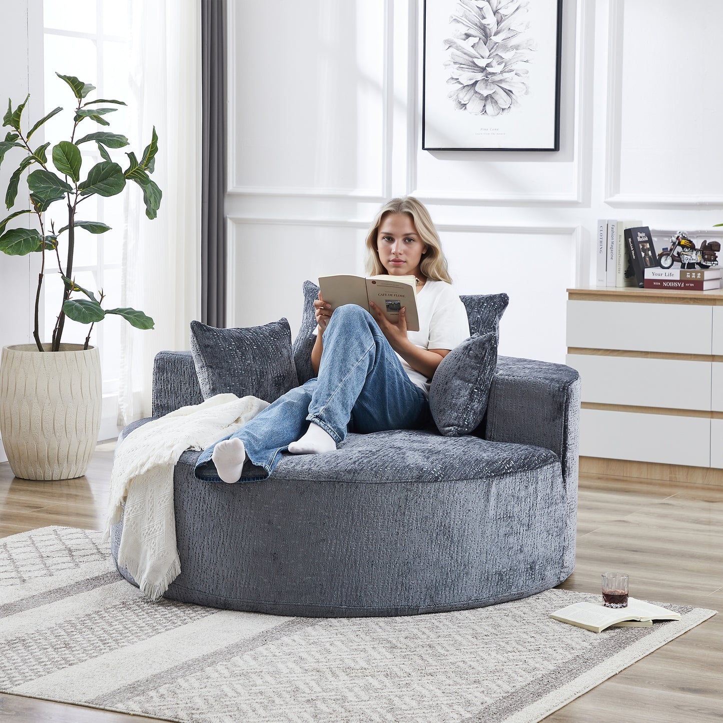 Plush grey circular sofa with textured fabric and plush cushions ideal for cozy living rooms